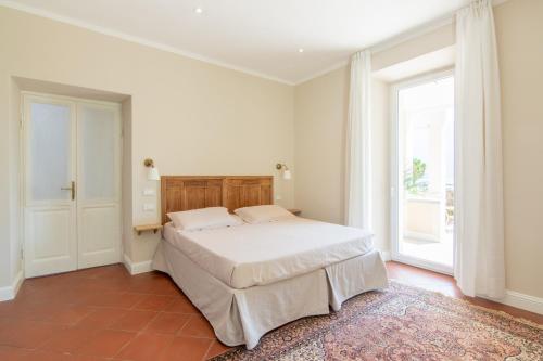 a bedroom with a bed and a large window at B&B Villa Eden jacuzzi pool in Domaso