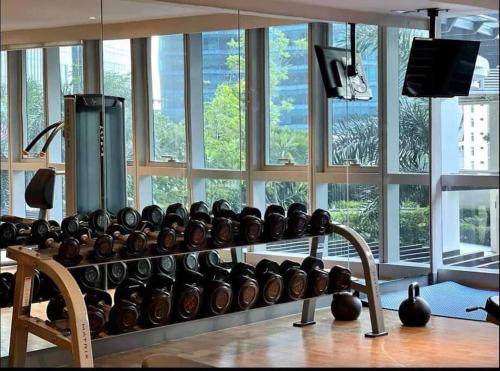 a gym with a rack with lots of windows at Tranquil Manor at Uptown BGC in Manila