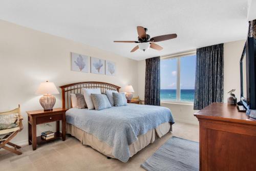 a bedroom with a bed and a window with the ocean at Island Princess 414 in Fort Walton Beach