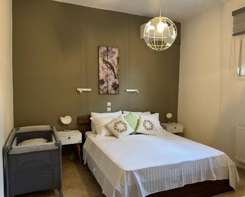 a bedroom with a bed and a chandelier at Kastri Treehouse in Nikiti