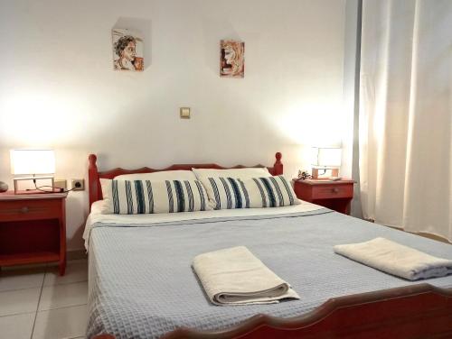 a bedroom with a bed with two towels on it at Rodi Apartments 1 in Kamari