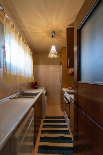 a kitchen with a sink and a counter top at Garden house - Asklipio in Kos