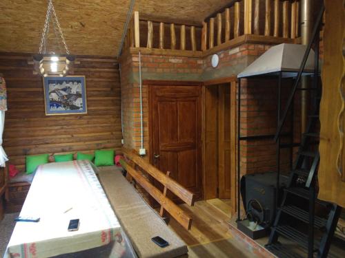 a small room with a bed and a ladder in it at Шаленарозі in Migovo