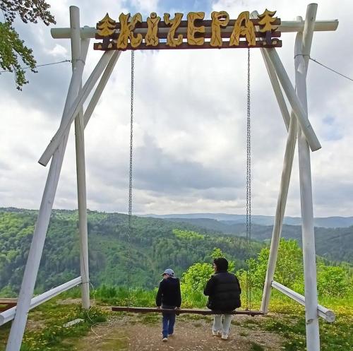 two people walking under a sign that reads wilderness at Шаленарозі in Migovo