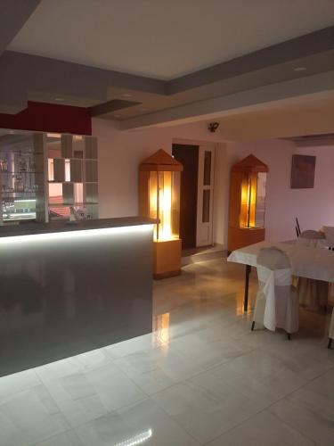 a kitchen and dining room with a table in a room at Pariska Noć in Loznica