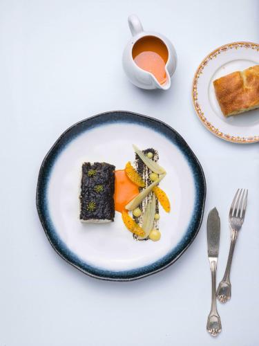 a plate of food on a table with a cup of tea at Relais et Chateaux La Bonne Étape in Château-Arnoux-Saint-Auban