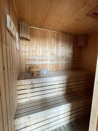 a wooden sauna with a bench in it at Seaview condo in Siracha (Free onzen) in Si Racha