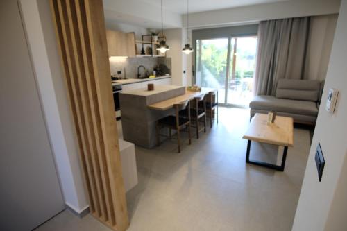 a kitchen and living room with a table and a couch at GREEN ESTATE villas in Arménoi