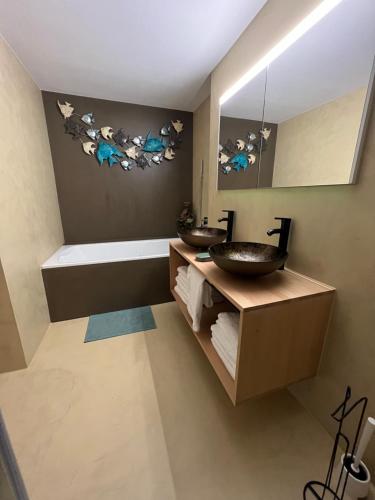a bathroom with two sinks and a bath tub at MARYS family friendly Apartments,VISIT RHINE FALLS for FREE if you stay 2 nights, SOHO 95m2 2-Bedrooms 2nd floor & SOUTH BEACH 105m2 3-Bedrooms & LOFT 115m2 3-Bedrooms Suite with Galerie,LOFT Netz 20m2, Pinball, Schaffhausen-Hemmental, Rheinfall 10 km in Schaffhausen