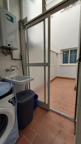 a bathroom with a toilet and a sink and a glass door at Piso en el Centro de Antequera in Antequera