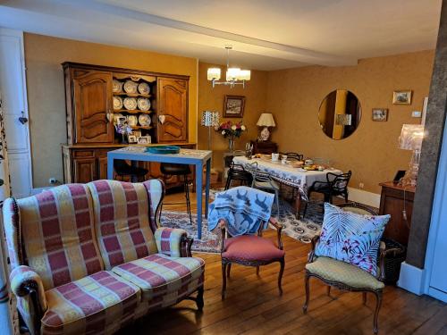 UN AIR MOULINOIS في مولان: غرفة معيشة مع طاولة وكراسي