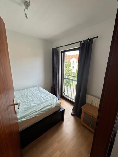 a bedroom with a bed and a large window at Apartment in Karlsruhe in Karlsruhe