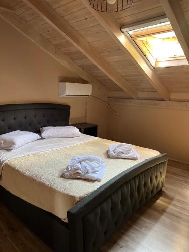 a bedroom with a bed with two towels on it at Michaela Loft in Póros Kefalonias