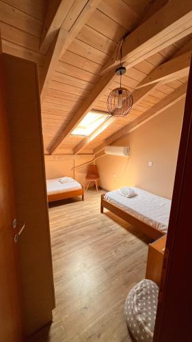 a room with two beds in a attic at Michaela Loft in Póros Kefalonias