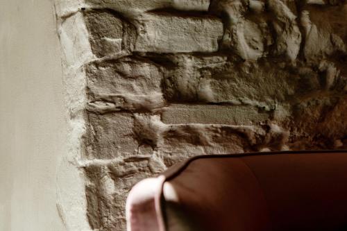 a close up of a brick wall at Suites Lorodellago Como - The House Of Travelers in Como
