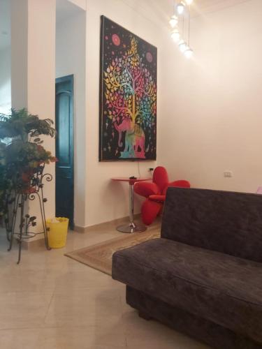 uma sala de estar com um sofá e uma pintura na parede em Studio em Dahab