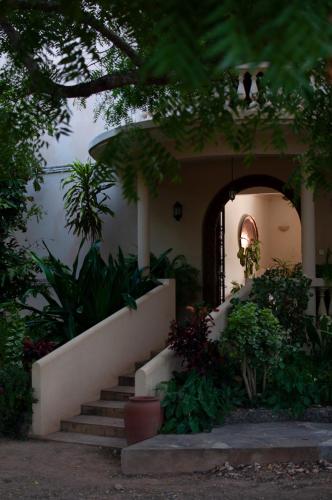 a house with a staircase in front of it at Maweni House - Beachfront, Pool, AC & Cook in Kilifi