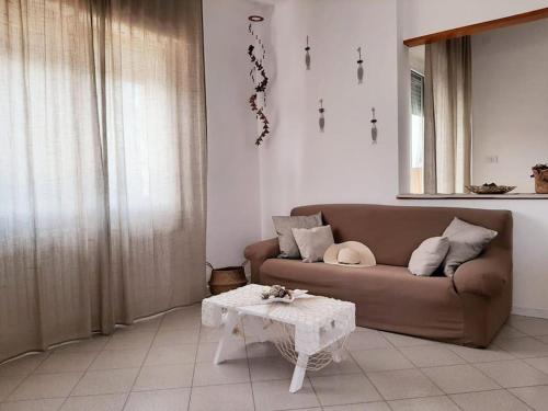 a living room with a couch and a table at Riccione la casetta del paese in Riccione