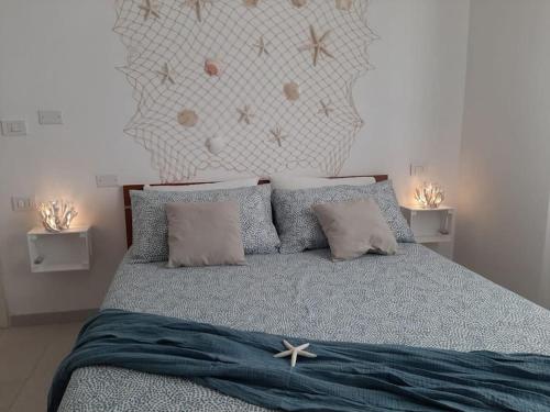 a bedroom with a bed with pillows and a head board at Riccione la casetta del paese in Riccione