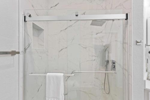 a shower with a glass door in a bathroom at The Epic Dublin Vista Cay Orlando in Orlando