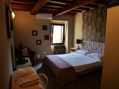 a bedroom with a large bed and a window at Al Cardinale in Viterbo