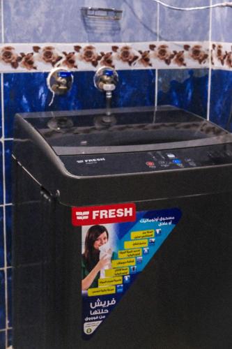 a sign that is on the side of a washing machine at Al-Manara Hostel Siwa Oasis in Siwa