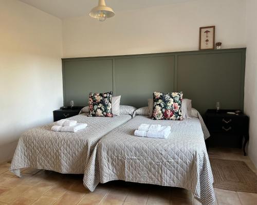 a bedroom with two beds with towels on them at La Morera in Alcaraz