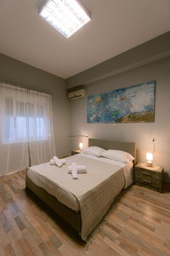 a bedroom with a bed with two towels on it at Armonia-Art House in Kos