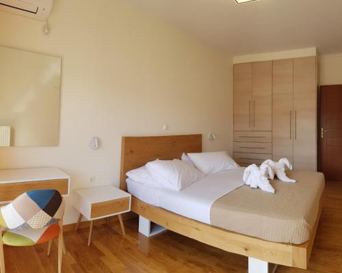 a bedroom with a bed with towels on it at villa strati in Nafplio