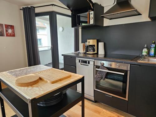 a kitchen with a table and a stove top oven at Cityappartements Weimar Bauhaus in Weimar