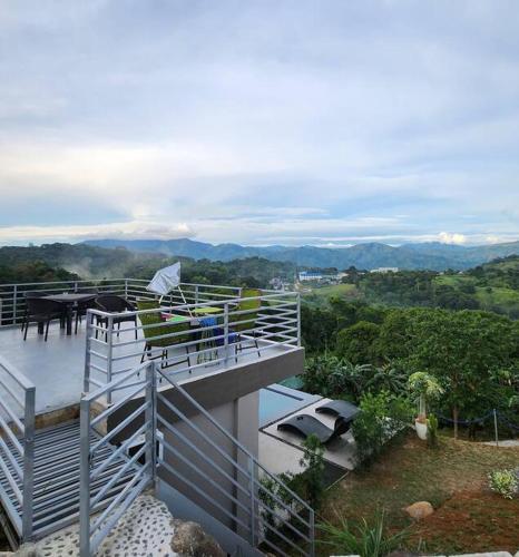 a balcony of a house with a view of the mountains at Skypad at the Observatory in Antipolo