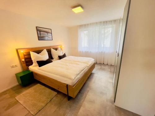 1 dormitorio con 1 cama grande con sábanas y almohadas blancas en Frevor - DESIGN L - I en Ulm