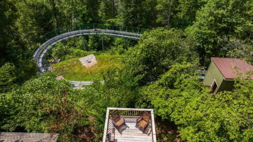 an overhead view of a roller coaster in a park at Whiskey Ridge Lodge, A Restored 1940s Gem, 2 Mins from Downtown, Breathtaking City Views, Custom Game Room, and Spacious Elegance in Gatlinburg