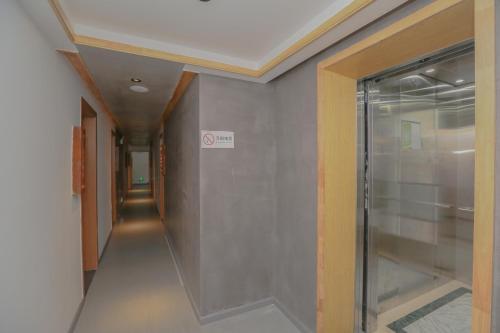 a hallway with a glass door in a building at Cozy Boutique Hotel in Zhangjiajie