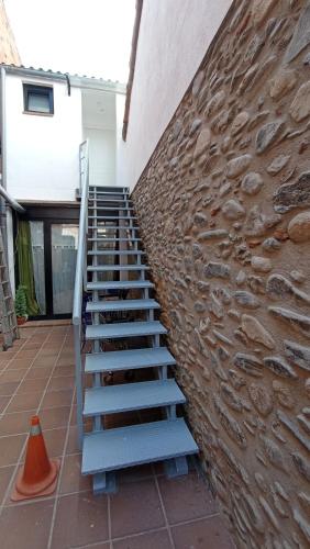 a set of stairs next to a brick wall at Apartament a Sant Celoni, Montseny, Barcelona in San Celoni