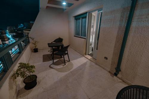 a balcony with a table and chairs on a building at Borg El Thaghr Hotel in Alexandria