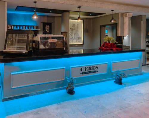 a bar in a restaurant with blue lighting at Borg El Thaghr Hotel in Alexandria