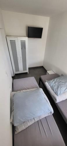 a room with two beds and a mirror at Noclegi Tuszyn in Tuszyn