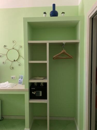 a room with a green wall with a desk at Vesuvio View in Vico Equense