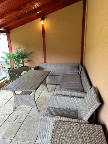 a patio with two benches and a table and chairs at Privát Lenka in Prosiek