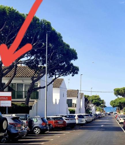 a row of cars parked in a parking lot at Cozy Chalet - playa a 200m in Chiclana de la Frontera