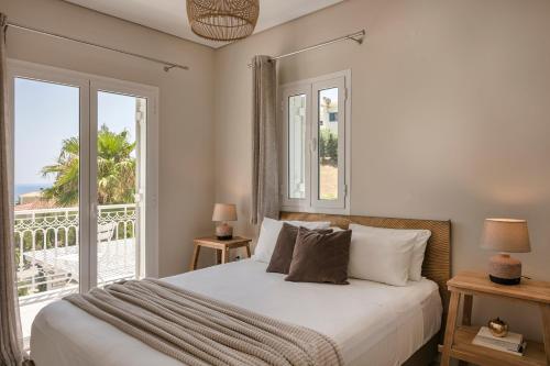 a bedroom with a bed with a view of the ocean at Sea View Villa Kefaloniaprivatevillas in Karavadhos