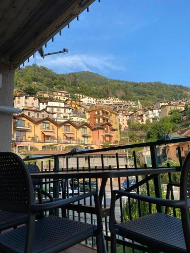 a balcony with chairs and a view of a city at Casa Mattia in Bellano