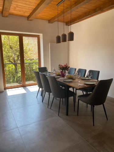 a dining room with a wooden table and chairs at Apartment Gemer & Apartment Volovec in Rožňava