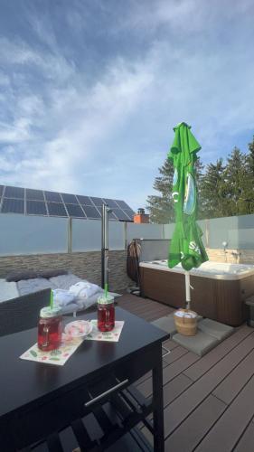 a patio with a table and a bath tub on a roof at Bed and Breakfast Kreft in Ljutomer