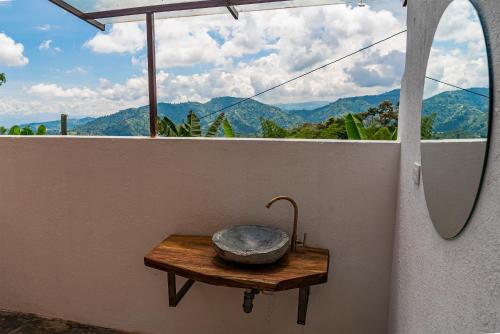 a bowl sitting on a wooden table on a balcony at Aldea Sabatinga in Manizales