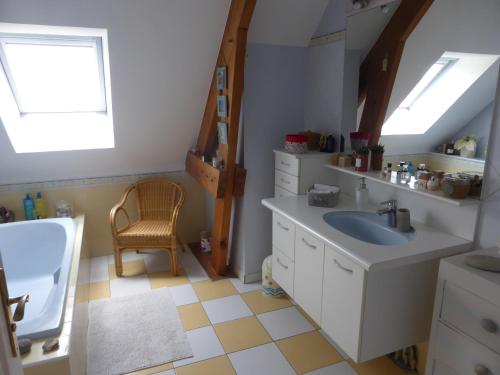 a bathroom with a sink and a toilet and a window at LA MARNE TRANQUILLE in Le Perreux-Sur-Marne