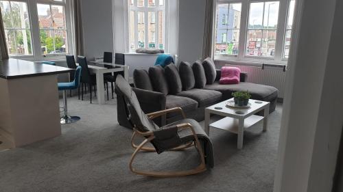 a living room with a couch and a table at Spacious 2-Bed 2-Bath Apartment with Free Parking - Central Poole in Poole