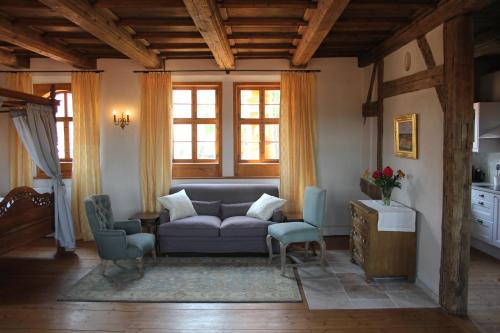 a living room with a couch and chairs at Domherrenhaus Meissen in Meißen