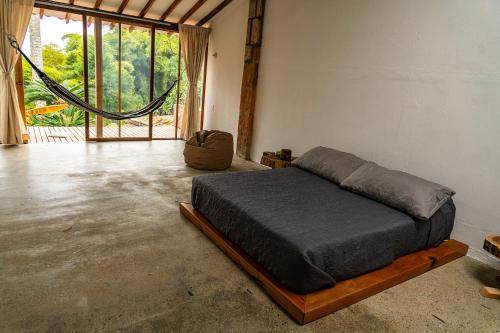a bedroom with a bed in a room with a window at Aldea Sabatinga in Manizales